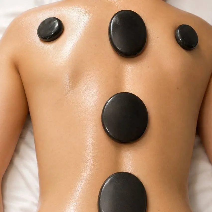 Dark basalt stones laid along an oiled back for a hot stone massage
